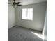 This bright bedroom features neutral walls, carpet, ceiling fan and window at 5023 Goshawk Ct, Brighton, CO 80601
