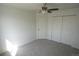 A bright bedroom features neutral walls, carpet, a ceiling fan and a closet at 5023 Goshawk Ct, Brighton, CO 80601