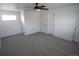 This is a bright bedroom with neutral walls, carpet, ceiling fan and closet at 5023 Goshawk Ct, Brighton, CO 80601