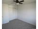 A bright bedroom features neutral walls, carpet, ceiling fan and closet at 5023 Goshawk Ct, Brighton, CO 80601