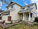 Well-maintained two-story home featuring a front porch with columns and a landscaped front yard at 5023 Goshawk Ct, Brighton, CO 80601