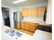 Kitchen features stainless steel appliances, light wood cabinets, and ample counter space at 5023 Goshawk Ct, Brighton, CO 80601