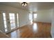 Living room with hardwood floors and a patio door leading to an outdoor seating area at 5023 Goshawk Ct, Brighton, CO 80601
