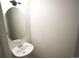 Powder room features a modern sink, oval mirror, and a neutral color palette at 5023 Goshawk Ct, Brighton, CO 80601