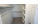 A walk-in closet features adjustable shelves and rods for optimal storage solutions at 5023 Goshawk Ct, Brighton, CO 80601