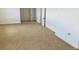 Bright bedroom featuring neutral carpet, white walls and trim and modern doors at 17362 County Road 29, Platteville, CO 80651