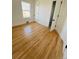 Bright bedroom showcasing wood floors, a window with natural light, and white trim at 17362 County Road 29, Platteville, CO 80651