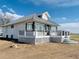 Rear exterior showcasing the expansive porch and updated design at 17362 County Road 29, Platteville, CO 80651