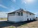 View of the side of the house with a metal roof, and white siding at 17362 County Road 29, Platteville, CO 80651