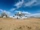 Charming exterior of home with a gray roof, white trim, and a large yard at 17362 County Road 29, Platteville, CO 80651