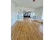 Open-concept living room featuring hardwood floors leading to a modern kitchen at 17362 County Road 29, Platteville, CO 80651