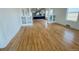 Open-concept living room showcasing hardwood floors that lead to a modern kitchen at 17362 County Road 29, Platteville, CO 80651