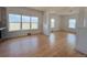 Bright and spacious living room with hardwood floors and large windows at 17362 County Road 29, Platteville, CO 80651