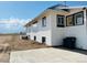 Exterior showing white siding with black trim, plus a back deck and concrete driveway at 17362 County Road 29, Platteville, CO 80651