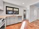 Modern kitchen with gray cabinets, stainless steel appliances, and terracotta floor at 1130 Locust St, Denver, CO 80220