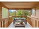 Relaxing balcony with wood railings and peaceful views of the surrounding trees and blue skies at 761 Carr St, Lakewood, CO 80214
