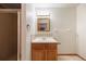Bathroom features a single sink vanity with a medicine cabinet and shower with glass door at 761 Carr St, Lakewood, CO 80214