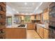 Well-lit kitchen with granite countertops, stainless appliances, and brick accents at 761 Carr St, Lakewood, CO 80214