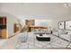 Spacious living room featuring a staircase, large windows, and stylish decor at 761 Carr St, Lakewood, CO 80214