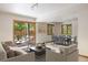 Bright living room with sliding glass doors to an outdoor patio, and a dining area with views of the yard at 761 Carr St, Lakewood, CO 80214