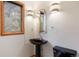 Chic powder room featuring a black pedestal sink, unique lighting fixtures, and a sleek design at 761 Carr St, Lakewood, CO 80214