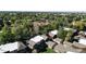 An aerial view shows a lovely neighborhood with mature trees and well-maintained townhome rooftops at 1242 S Crystal Way, Aurora, CO 80012