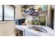 Bright laundry room featuring modern washer and dryer with storage shelves for supplies at 1242 S Crystal Way, Aurora, CO 80012