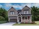 Charming two-story home featuring a covered porch, attached garage, and professional landscaping at 1361 Lumber Ridge N Cir, Erie, CO 80516
