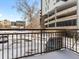 Balcony view with railing and a 'For Sale' sign, overlooking a snowy parking area at 740 N Sherman St # 208, Denver, CO 80203