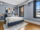 Charming bedroom with a large window, hardwood floors, modern lighting, and stylish decor at 740 N Sherman St # 208, Denver, CO 80203