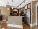 Kitchen featuring dark wood cabinets, stainless steel appliances, and stylish pendant lighting at 740 N Sherman St # 208, Denver, CO 80203