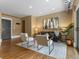 Bright living room features a gray sofa, two chairs, hardwood floors, and an abstract painting at 740 N Sherman St # 208, Denver, CO 80203