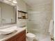 Bathroom features a sleek vessel sink, modern vanity, decorative shelving, and a glass-enclosed shower for a spa-like experience at 11358 W 85Th Pl # E, Arvada, CO 80005