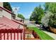 Deck view showcasing neighborhood greenery, neighboring rooftops, and a street view at 11358 W 85Th Pl # E, Arvada, CO 80005