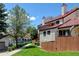 Exterior view of townhomes with red roofs, private decks, and well-maintained lawns at 11358 W 85Th Pl # E, Arvada, CO 80005