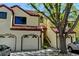 Exterior of a home featuring attached garages and a staircase leading to an upper-level entrance at 11358 W 85Th Pl # E, Arvada, CO 80005