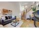 This living room features a staircase with sleek metal railings and a ceiling fan at 11358 W 85Th Pl # E, Arvada, CO 80005