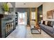 Inviting living room features a fireplace with decorative tile, hardwood floors and plenty of natural light at 11358 W 85Th Pl # E, Arvada, CO 80005