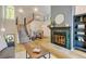 Bright living room featuring a fireplace with decorative tile, and stairs with modern railings to the second level at 11358 W 85Th Pl # E, Arvada, CO 80005