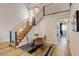 Bright living space featuring modern light fixture, open staircase, and wood floors at 11358 W 85Th Pl # E, Arvada, CO 80005