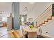 Sunlit living spaces boast hardwood floors, fireplace, and staircase with metal railing at 11358 W 85Th Pl # E, Arvada, CO 80005