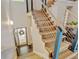 Modern staircase with light wood treads, sleek metal railings, and an open design that enhances the home's bright interior at 11358 W 85Th Pl # E, Arvada, CO 80005