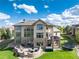 Sprawling backyard with outdoor entertaining, stone retaining wall, trampoline, and seating at 5409 Sedona Dr, Parker, CO 80134