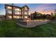 Expansive backyard showcasing a well-maintained lawn, patio area, and outdoor lighting at 5409 Sedona Dr, Parker, CO 80134