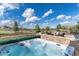 Outdoor patio offers beautiful hot tub, stone surround, outdoor seating, and a view of the lush green yard at 5409 Sedona Dr, Parker, CO 80134