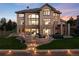 Outdoor entertaining backyard patio, stone retaining wall, outdoor fireplace, and hot tub at 5409 Sedona Dr, Parker, CO 80134