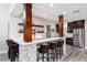 Basement bar featuring a white countertop, stone accents, and modern appliances, perfect for entertaining guests at 5409 Sedona Dr, Parker, CO 80134