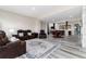 Finished basement with a large seating area, stone fireplace, bar, wood floors, and ample lighting at 5409 Sedona Dr, Parker, CO 80134