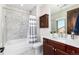 Elegant bathroom featuring a dark wood vanity, quartz countertop, and tiled shower and tub at 5409 Sedona Dr, Parker, CO 80134
