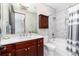 Elegant bathroom with a dark wood vanity, quartz countertop, and tiled shower and tub at 5409 Sedona Dr, Parker, CO 80134